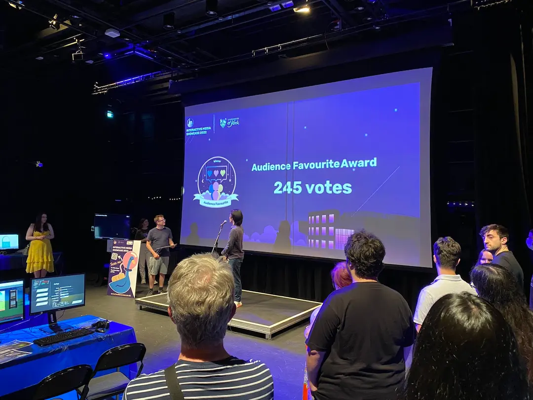 A photo taken during the award ceremony in 2022 showing co-director Edmund Wei presenting the number of votes for the audience-favourite award